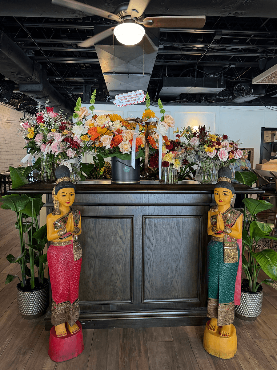 Traditional Thai-Lao-Khmer welcoming statues at Naga Bistro